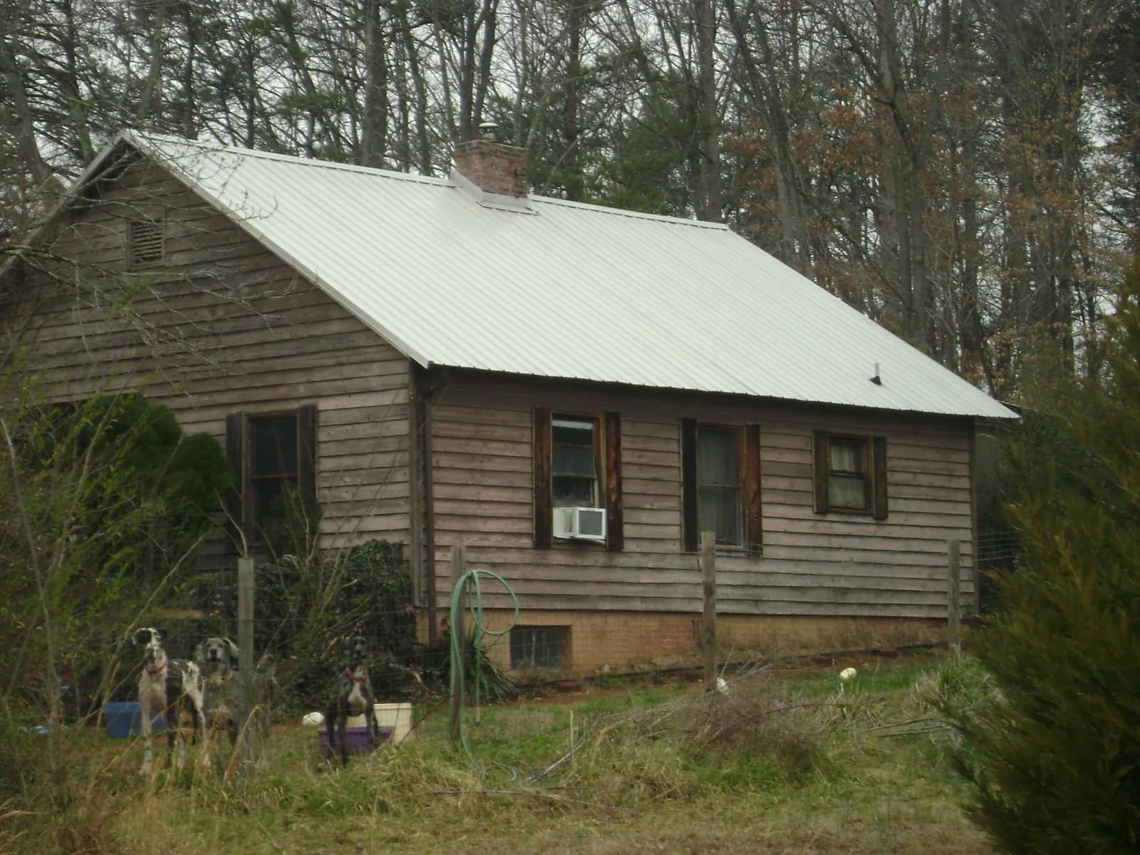 White metal roof on an old wood sided farmhouse, from a Metal Roof Installation job in Little Neck
